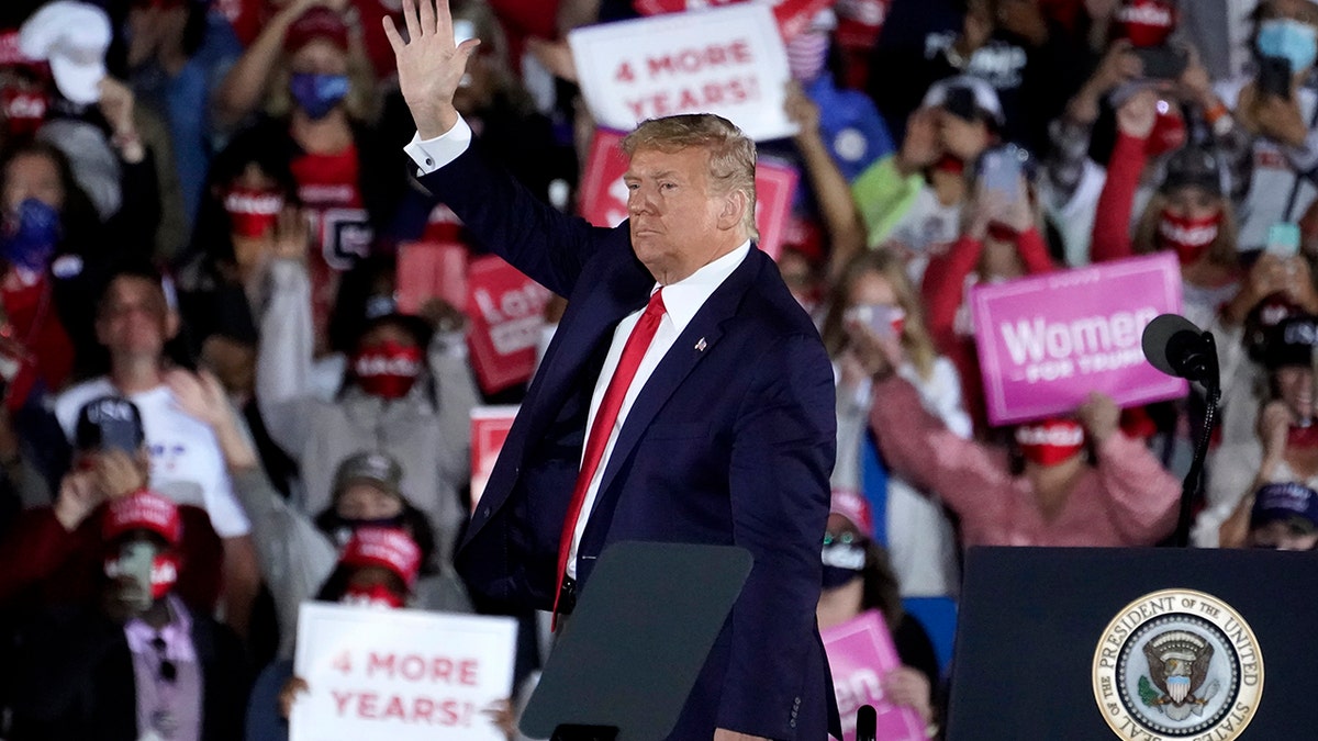President Donald Trump waves as he leaves after speaking at a campaign rally at Middle Georgia Regional Airport in Macon, Georgia, on Oct. 16, 2020.