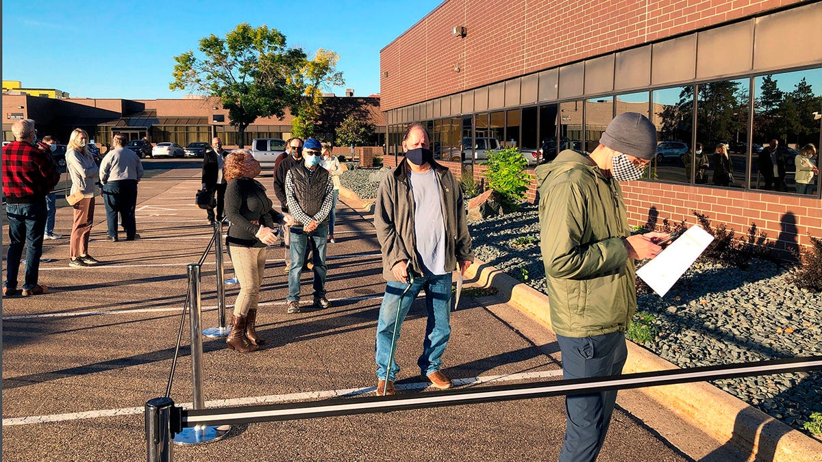 Voters line up outside of the Minneapolis early voting center as Minnesota opened early voting for the general election.. (AP Photo/Steve Karnowski, File)