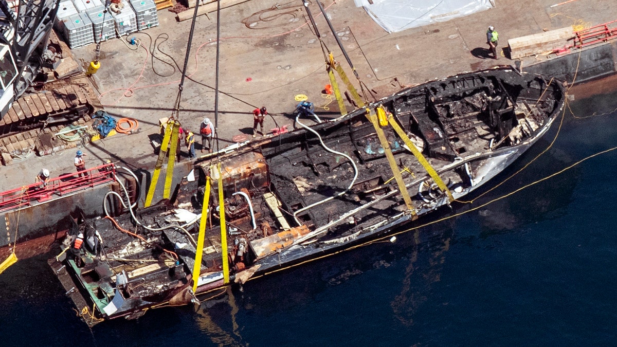 In this Sept. 12, 2019, file photo, the burned hull of the dive boat Conception is brought to the surface by a salvage team off Santa Cruz Island, Calif. (Brian van der Brug/Los Angeles Times via AP)