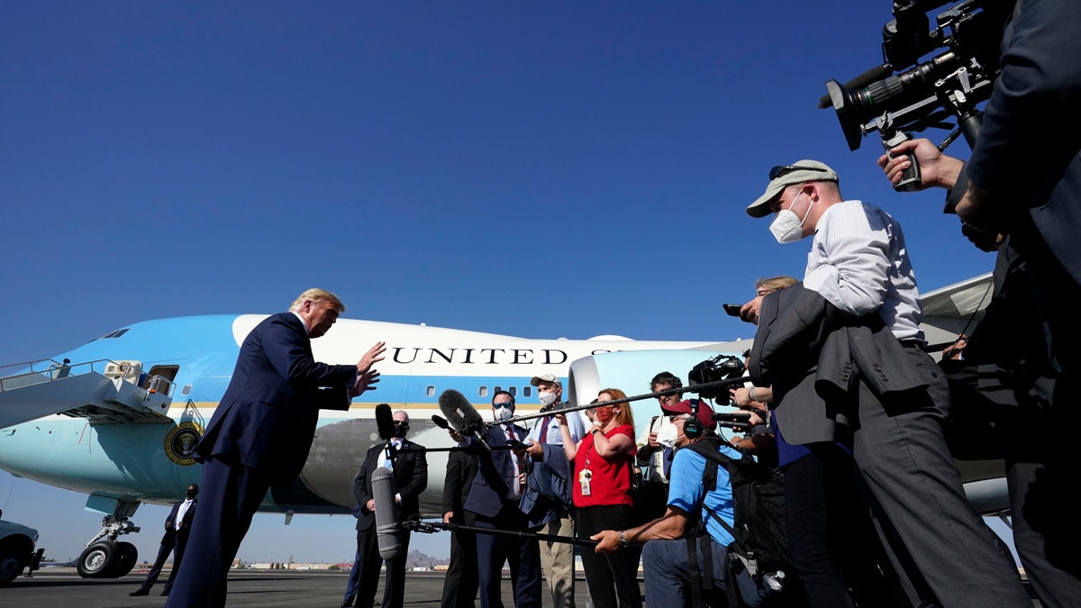 President Trump speaks to reporters at Phoenix Sky Harbor International Airport, Monday, Oct. 19, 2020, in Phoenix. (AP Photo/Alex Brandon)