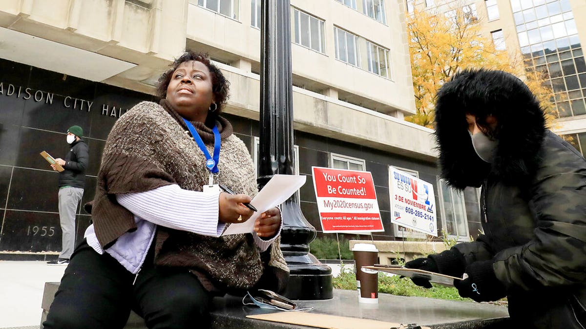 Madison, Wis. residents Theola Carter, left, and Carrie Braxton fill out their ballots on the first day of the state's in-person absentee voting window for the Nov. 3 election. (John Hart/Wisconsin State Journal via AP)
