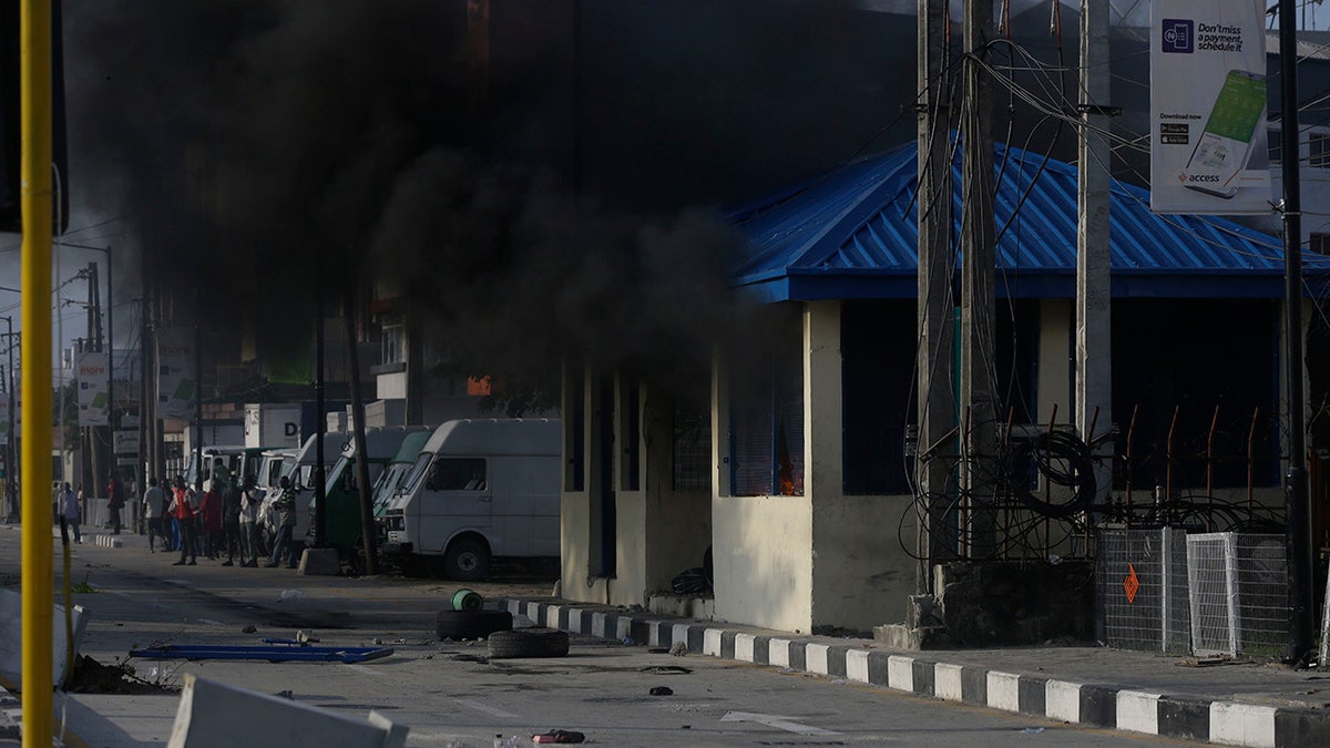 After 13 days of protests against alleged police brutality, authorities have imposed a 24-hour curfew in Lagos, Nigeria's largest city, as moves are made to stop growing violence. ( AP Photo/Sunday Alamba)