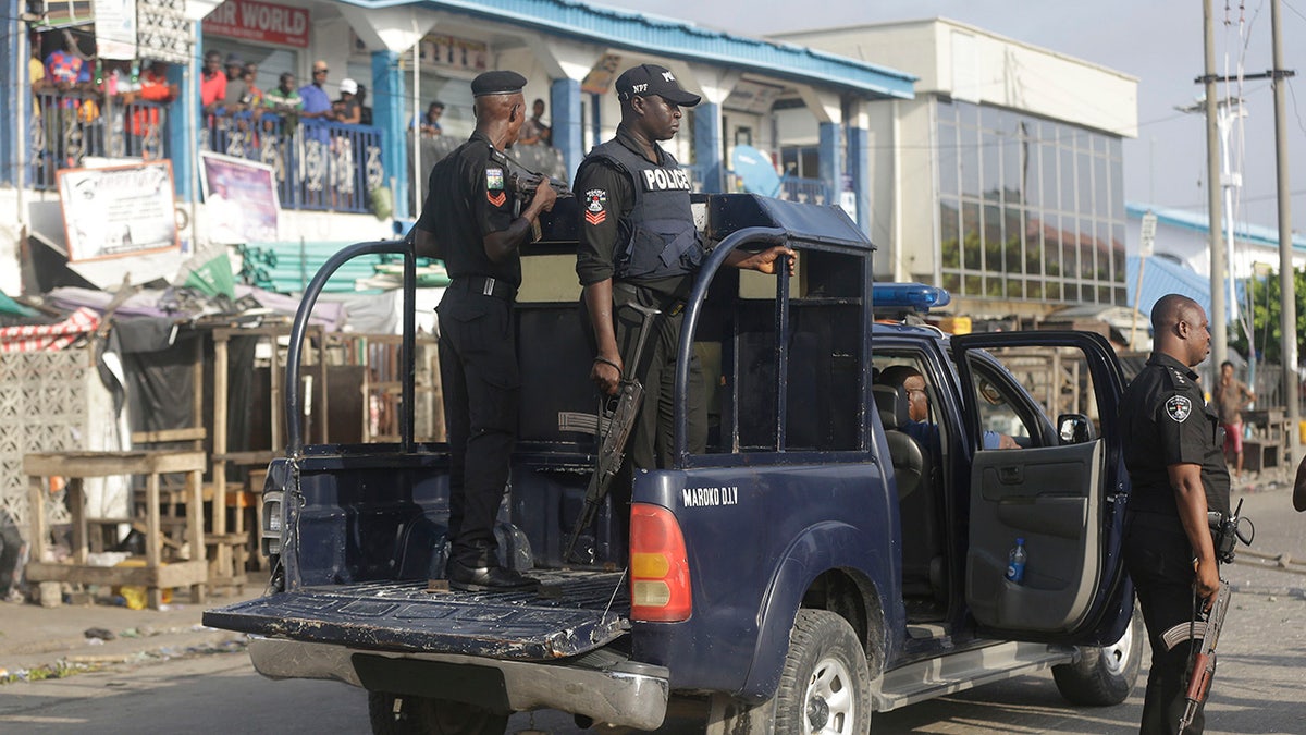 Police officers patrol near the Lekki toll gate in Lagos, Nigeria, Wednesday Oct. 21, 2020. ( AP Photo/Sunday Alamba)