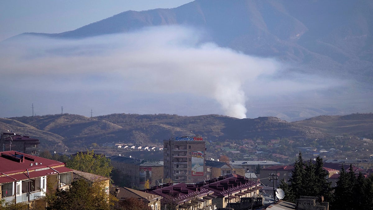 Smoke rises after shelling by Azerbaijan's artillery during a military conflict in Stepanakert, the separatist region of Nagorno-Karabakh, Saturday, Oct. 24, 2020. The heavy shelling forced residents of Stepanakert, the regional capital of Nagorno-Karabakh, into shelters, as emergency teams rushed to extinguish fires. Nagorno-Karabakh authorities said other towns in the region were also targeted by Azerbaijani artillery fire. (AP Photo)