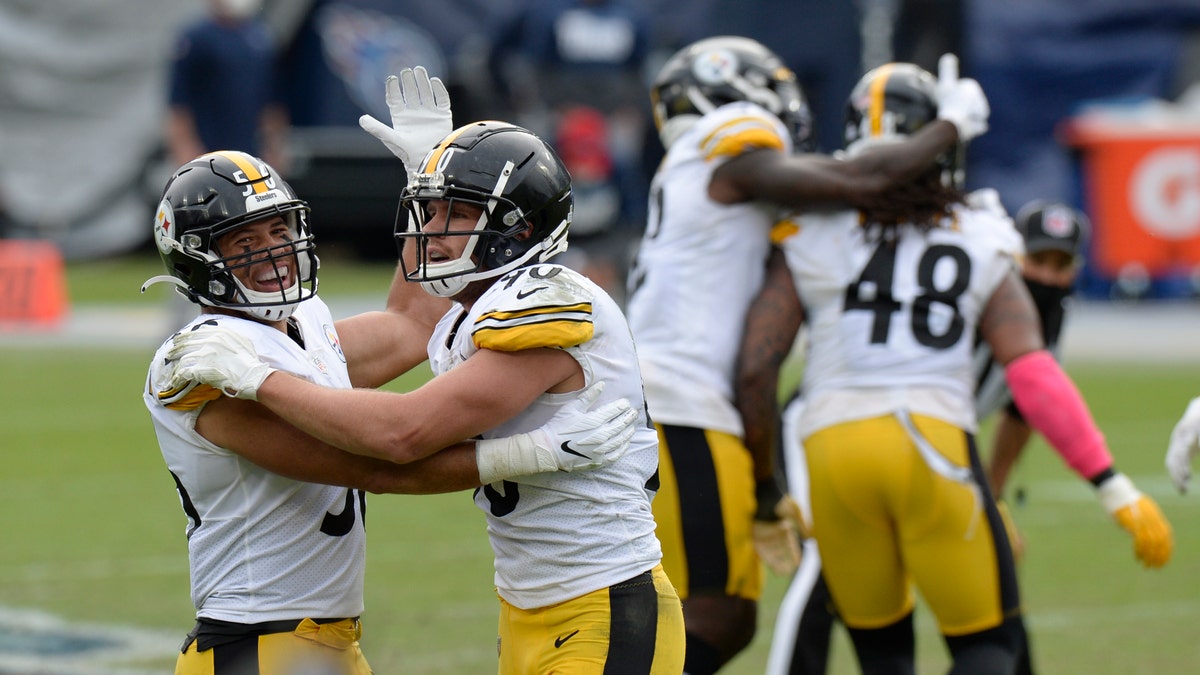Pittsburgh Steelers linebackers Alex Highsmith (56) and T.J. Watt (90) celebrate after a 45-yard field goal attempt by Tennessee Titans kicker Stephen Gostkowski was no good in the final seconds of the fourth quarter in an NFL football game Sunday, Oct. 25, 2020, in Nashville, Tenn. The Steelers won 27-24. (AP Photo/Mark Zaleski)