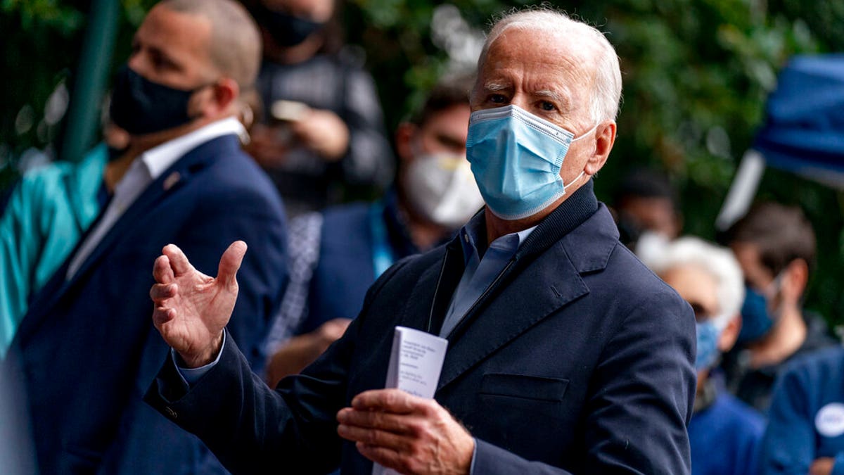 Democratic presidential candidate former Vice President Joe Biden speaks with people outside a voter service center, Monday, Oct. 26, 2020, in Chester, Pa.