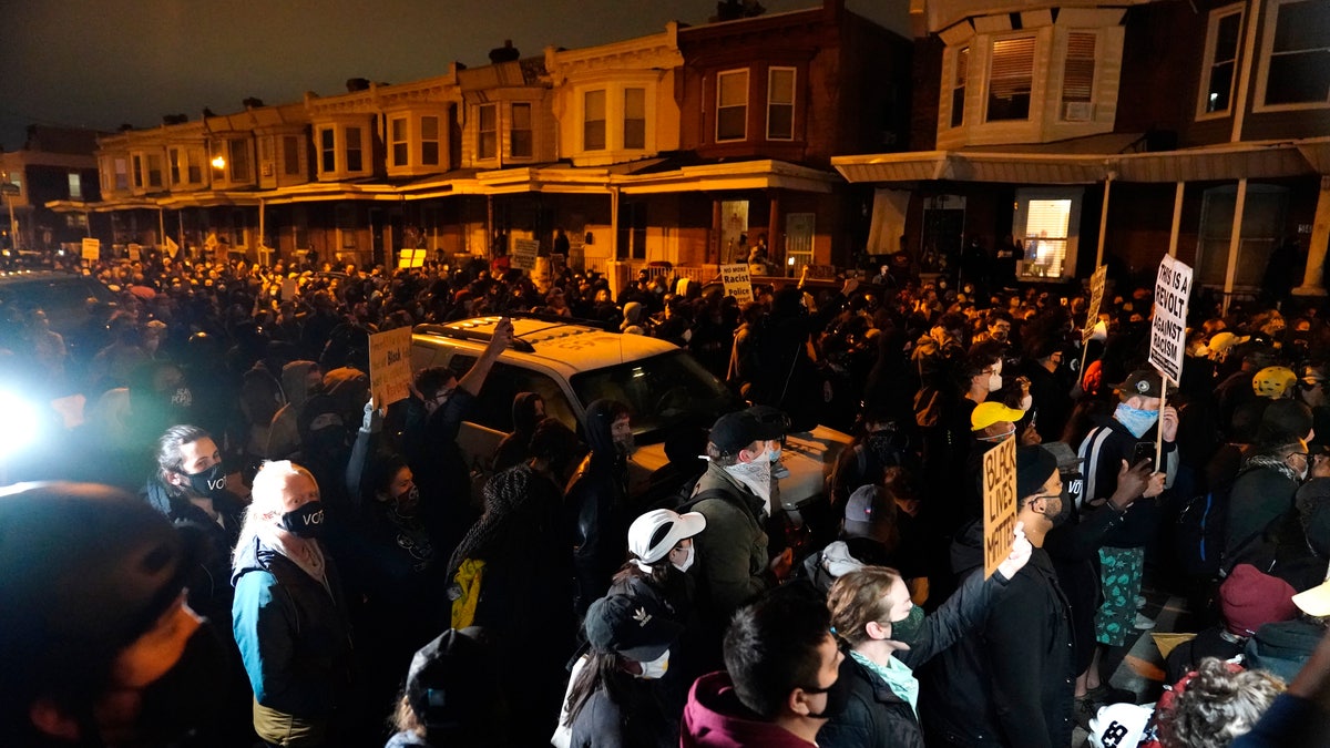 Protesters confront police during a march Tuesday, Oct. 27, 2020, in Philadelphia.  (AP Photo/Matt Slocum)