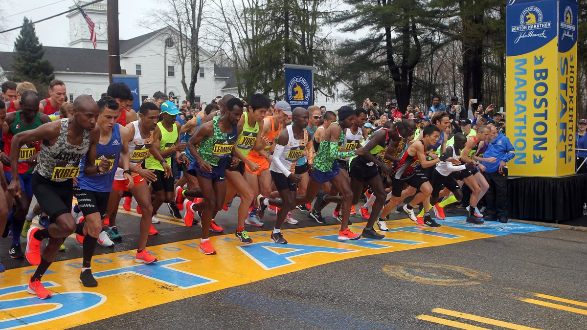 FILE - In this April 15, 2019, file photo, the elite men break from the start of the 123rd Boston Marathon in Hopkinton, Mass. Next year’s Boston Marathon has been postponed. The Boston Athletic Association says that it won’t hold the race as scheduled in April because of the COVID-19 pandemic. Organizers say it will be put off “at least until the fall of 2021.” This year’s marathon was initially postponed until the fall and later canceled outright. (AP Photo/Stew Milne, File)