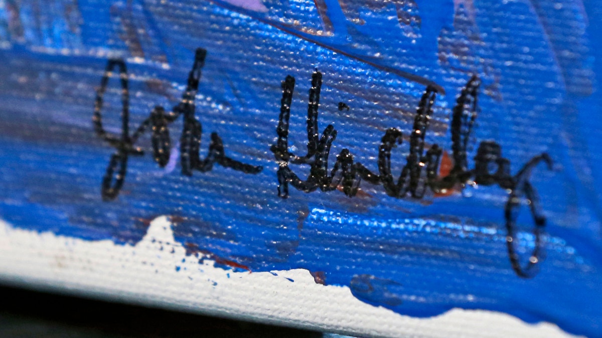 In this photo taken March 18, 2015, the signature on a painting by John Hinkley is seen in Hampton, Va. (AP Photo/Steve Helber)