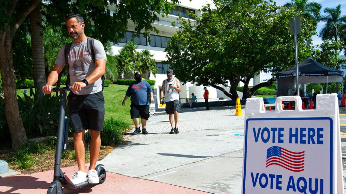People leave after casting their vote during early voting for the general election at Miami Beach City Hall, on Wednesday, Oct. 28, 2020, in Miami Beach, Fla. (David Santiago/Miami Herald via AP)