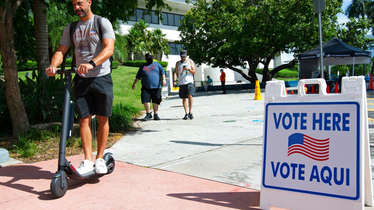 People leave after casting their vote during early voting for the general election at Miami Beach City Hall, on Wednesday, Oct. 28, 2020, in Miami Beach, Fla. (David Santiago/Miami Herald via AP)