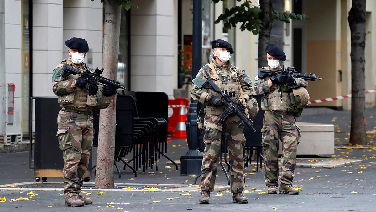 Soldiers patrol near Notre Dame church in Nice, southern France, Thursday after an attacker armed with a knife killed three people at a church. (Eric Gaillard/Pool via AP)