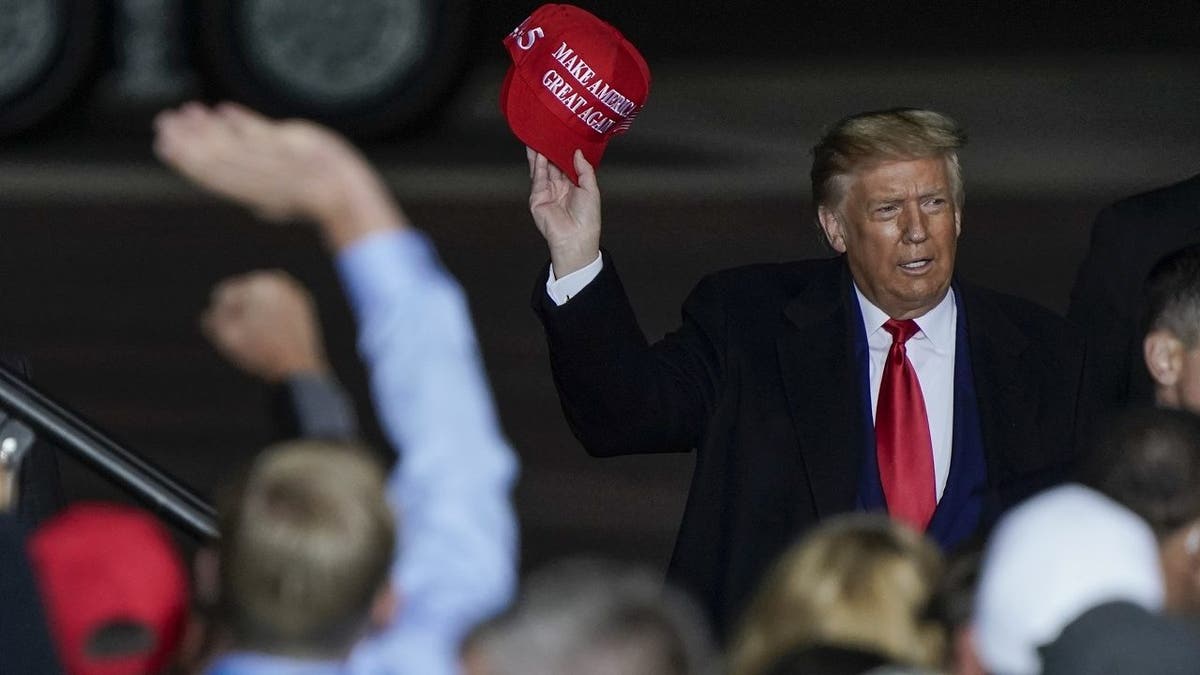 FILE - In this Sept. 17, 2020 file photo President Donald Trump throws a hat to the crowd after speaking at a campaign rally at the Central Wisconsin Airport in Mosinee, Wis. (AP Photo/Morry Gash, File)