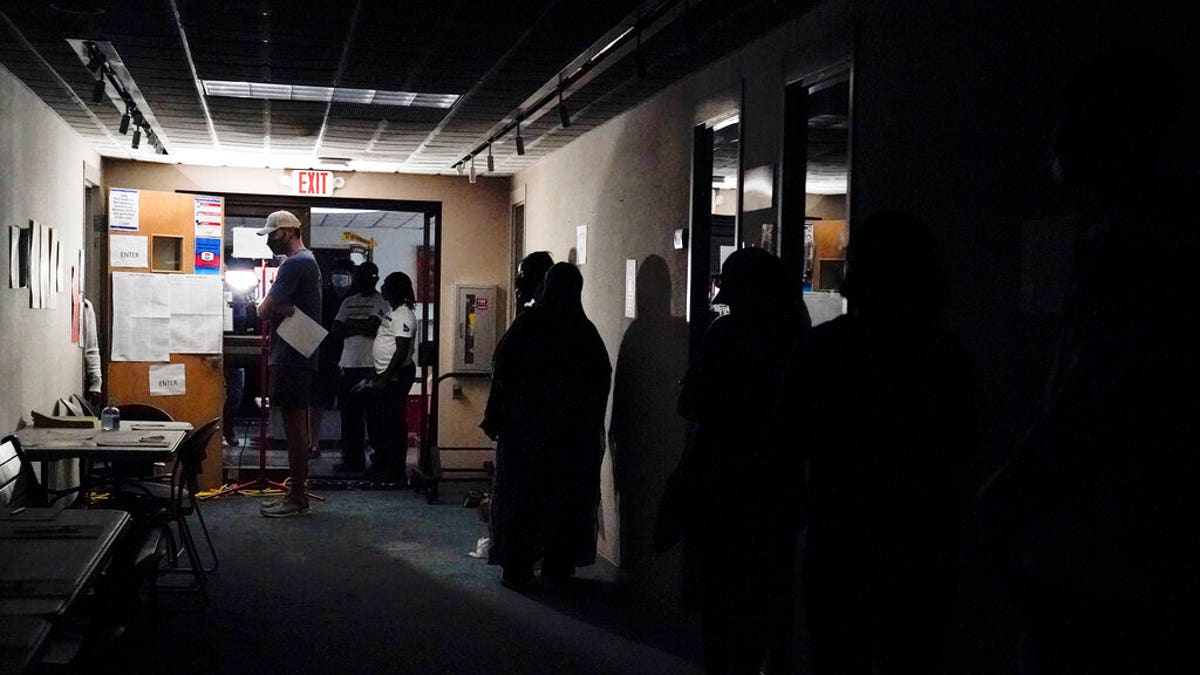 A line of voters forms during early voting at the Dunwoody Library after Hurricane Zeta knocked out power in the surrounding areas on Oct. 29, 2020, in Dunwoody, Ga. 