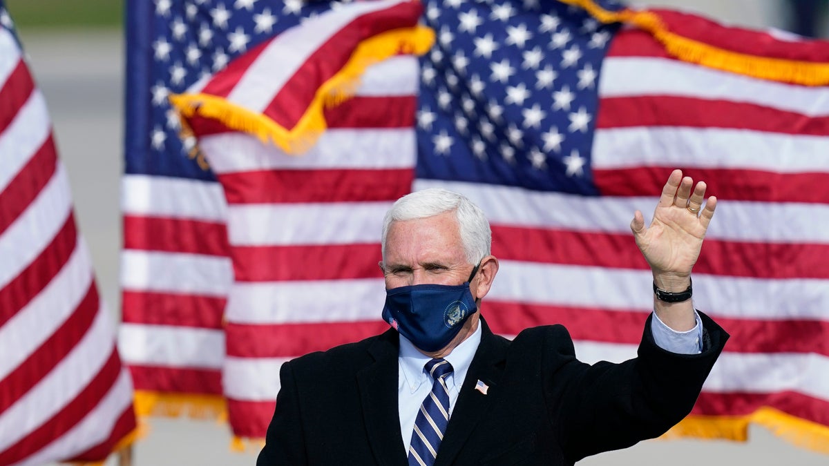 Vice President Mike Pence wears a face mask as he arrives for an airport rally, Thursday, Oct. 29, 2020, in Des Moines, Iowa. (AP Photo/Charlie Neibergall)