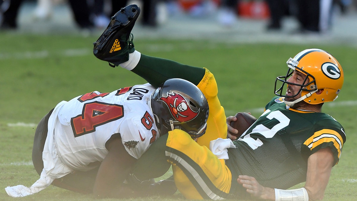 Green Bay Packers quarterback Aaron Rodgers (12) gets sacked by Tampa Bay Buccaneers inside linebacker Lavonte David (54) during the first half of an NFL football game Sunday, Oct. 18, 2020, in Tampa, Fla. (AP Photo/Jason Behnken)