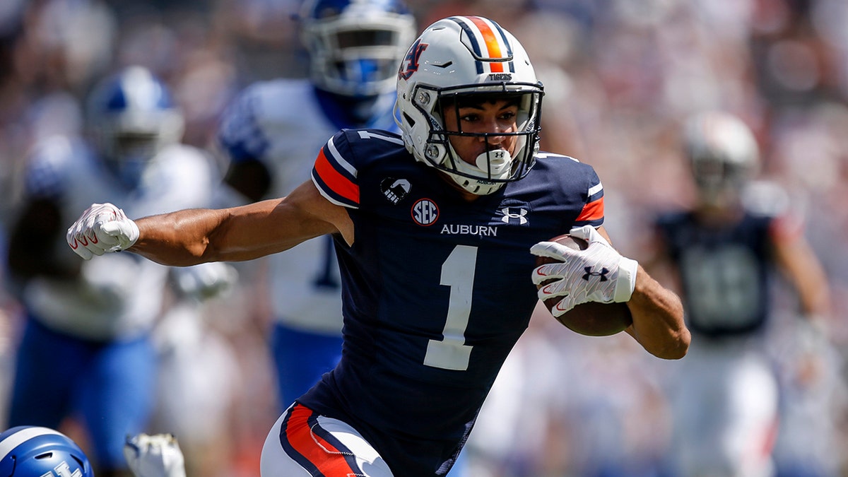 Auburn wide receiver Anthony Schwartz (1) catches a pass against Kentucky and carries for a first down during the first quarter of an NCAA college football game on Saturday, Sept. 26, 2020, in Auburn, Ala. (AP Photo/Butch Dill)