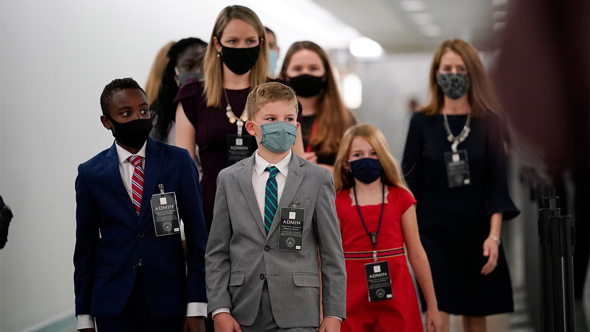 The children of Supreme Court nominee Amy Coney Barrett arrive on Capitol Hill before she will begin her confirmation hearing before the Senate Judiciary Committee, Monday, Oct. 12, 2020 on Capitol Hill in Washington. (AP Photo/J. Scott Applewhite)