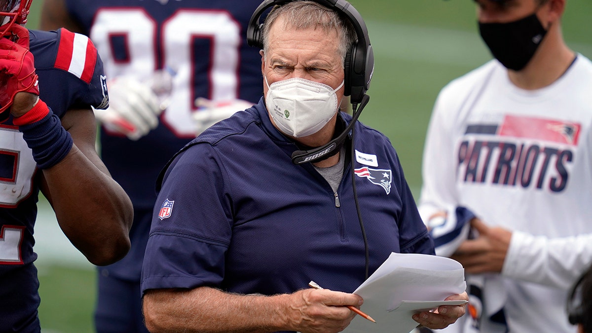 New England Patriots head coach Bill Belichick works along the sideline in the first half of an NFL football game against the Las Vegas Raiders, Sunday, Sept. 27, 2020, in Foxborough, Mass. (AP Photo/Charles Krupa)