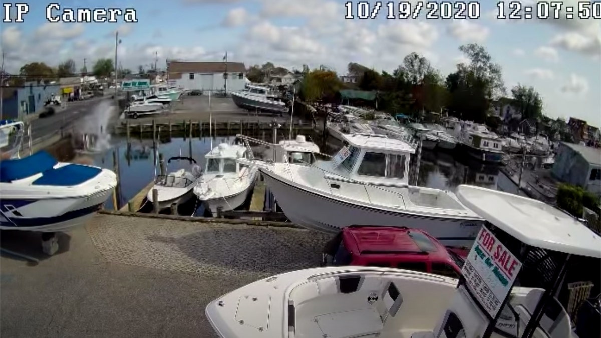 Screen grab from surveillance footage showing vehicle crashing into a canal on Long Island Monday.