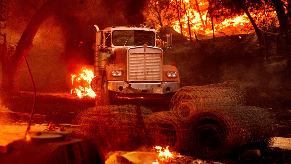 Flames from the Glass Fire burn a truck in a Calistoga, Calif., vineyard Thursday, Oct. 1, 2020.