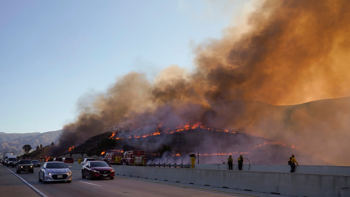 Crews tried to beat back two out-of-control wildfires in Southern California that have kept tens of thousands of people out of their homes.