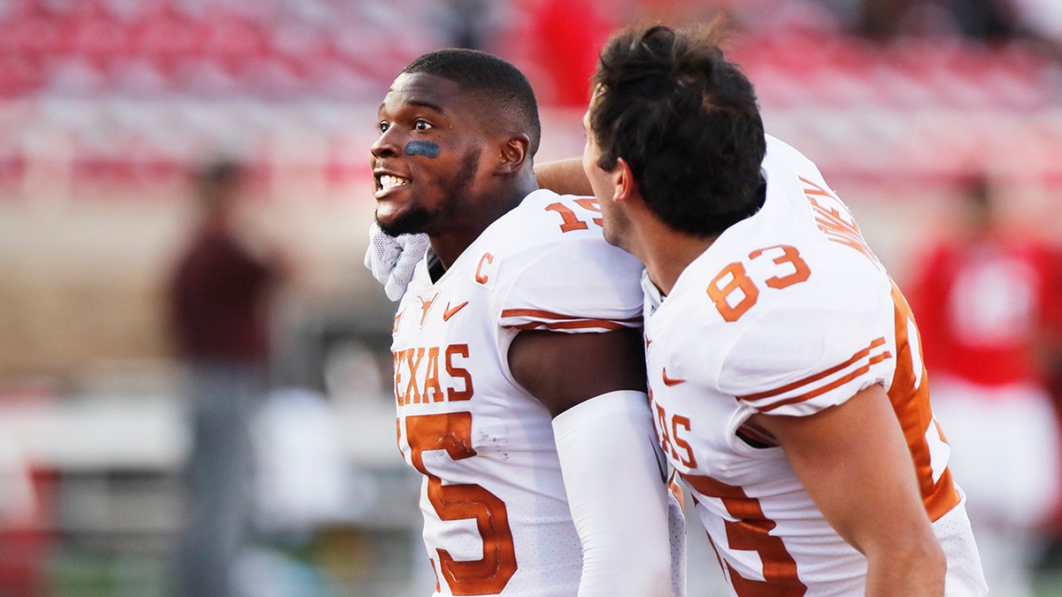 Texas defensive back Chris Brown and wide receiver Kai Money celebrate their win over Texas Tech after an NCAA college football game against Texas Tech, Saturday, Sept. 26, 2020, in Lubbock, Texas. (AP Photo/Mark Rogers)