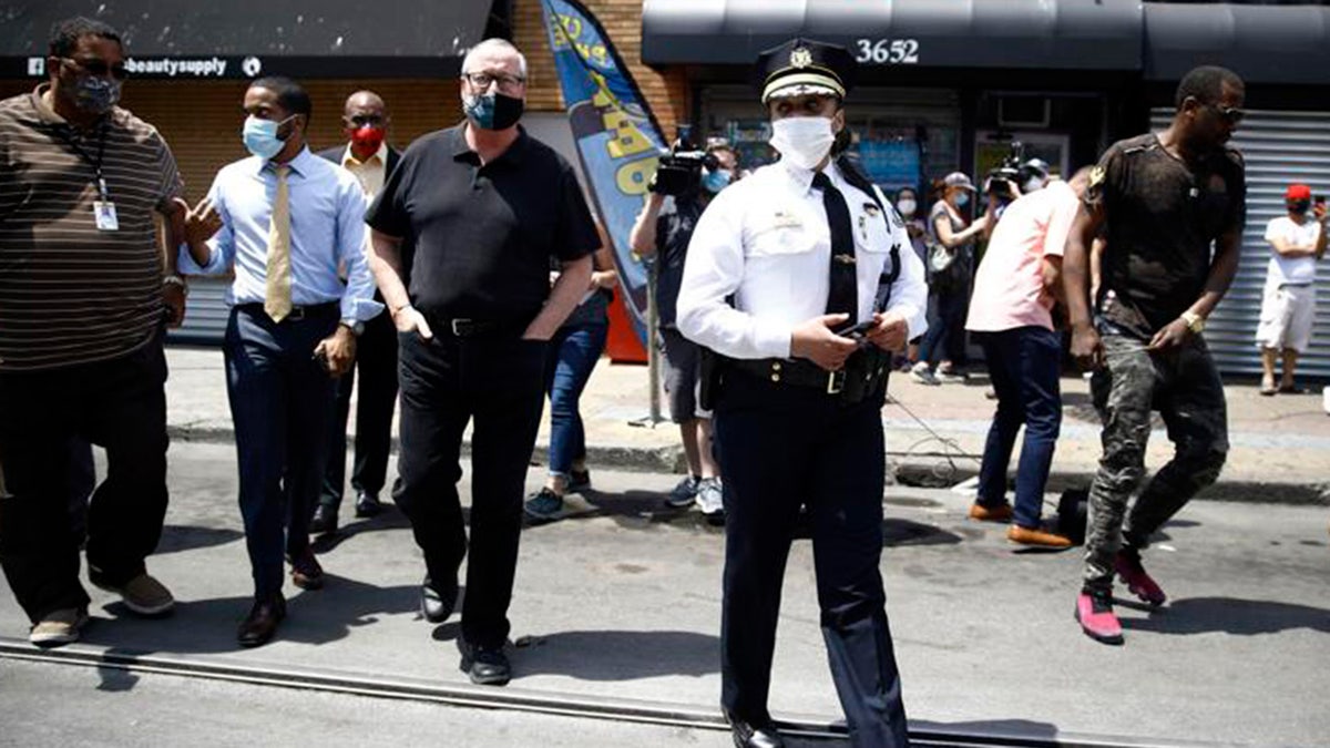 Philadelphia Police Commissioner Danielle Outlaw, center, and Mayor Jim Kenney, 4th left, meet with people, Thursday, June 4, 2020, in Philadelphia. (AP Photo/Matt Rourke)