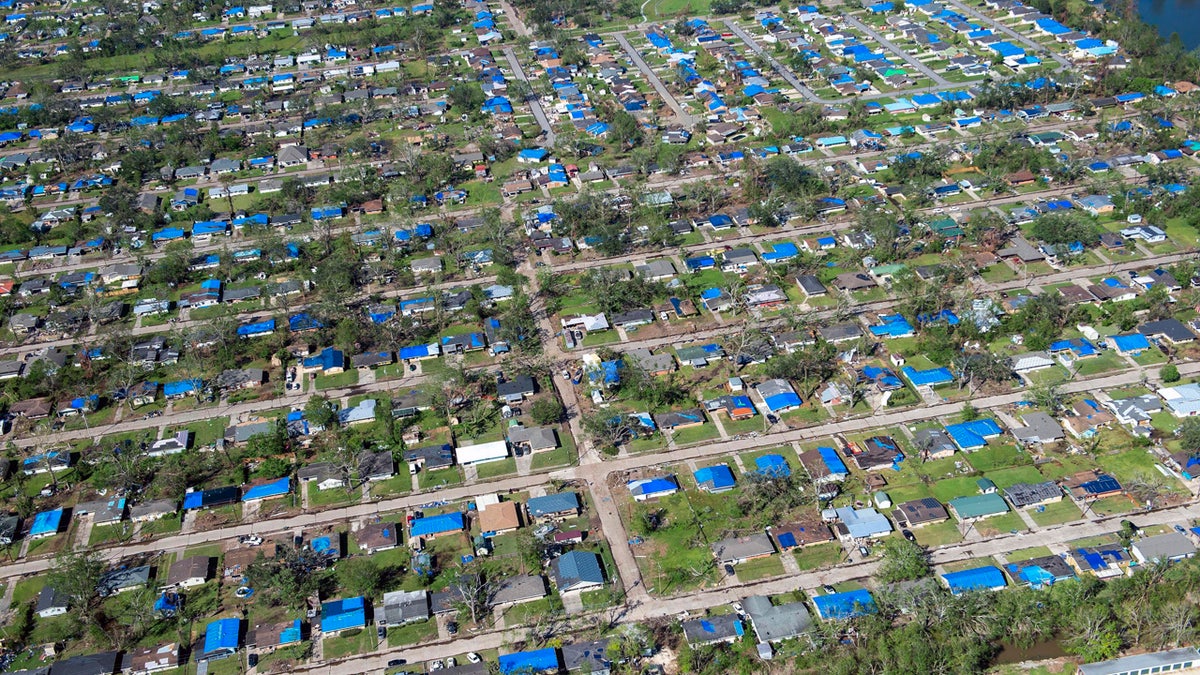 Blue tarps cover houses in the aftermath of Hurricane Delta, Saturday Oct. 10, 2020, in Lake Charles, La.