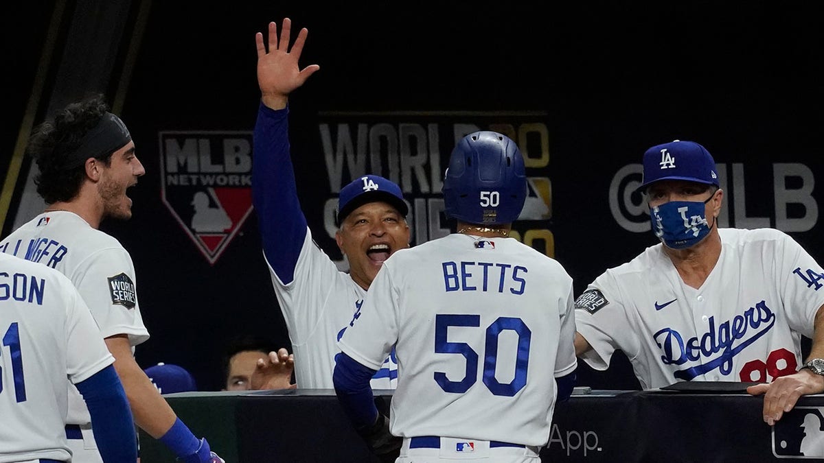 Dodgers celebrate Mookie Betts' go-ahead run. (AP Photo/Tony Gutierrez)