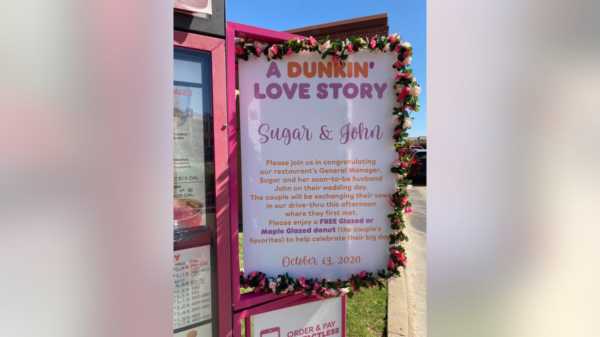 A sign posted near the drive-thru menu welcomed locals to come celebrate the wedding with a free doughnut.