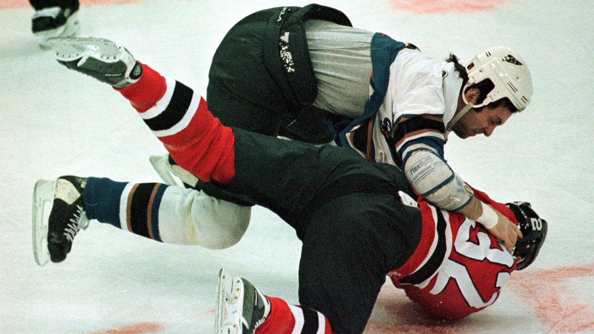 Washington Capitals' Enrico Ciccone (top) throws New Jersey Devils' Sasha Lakovic down to the ice as the two tangled in the first period at MCI Center December 30. Lakovic received a five minute fighting penalty, and Ciccone, five minutes also, plus a 10 minute misconduct for hitting Lakovic while both players were restrained by the officials. (Reuters)