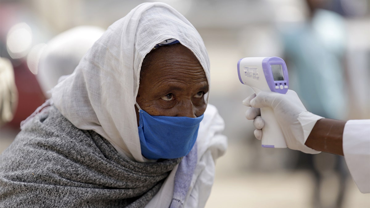 Officials take Lideta Church visitors' temperature as a precaution against the novel coronavirus (Covid-19) pandemic in Addis Ababa, Ethiopia on June 9. (Photo by Minasse Wondimu Hailu/Anadolu Agency via Getty Images)