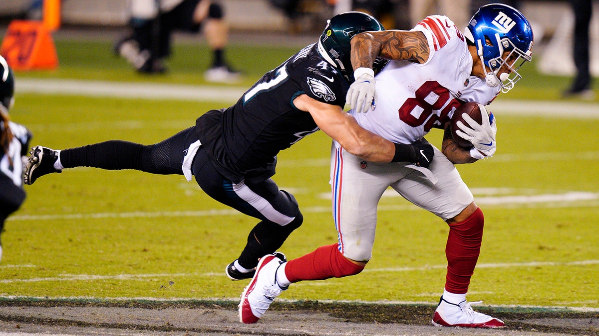 New York Giants' Evan Engram (88) tries to get past Philadelphia Eagles' Nathan Gerry (47) during the first half of an NFL football game, Thursday, Oct. 22, 2020, in Philadelphia. (AP Photo/Chris Szagola)