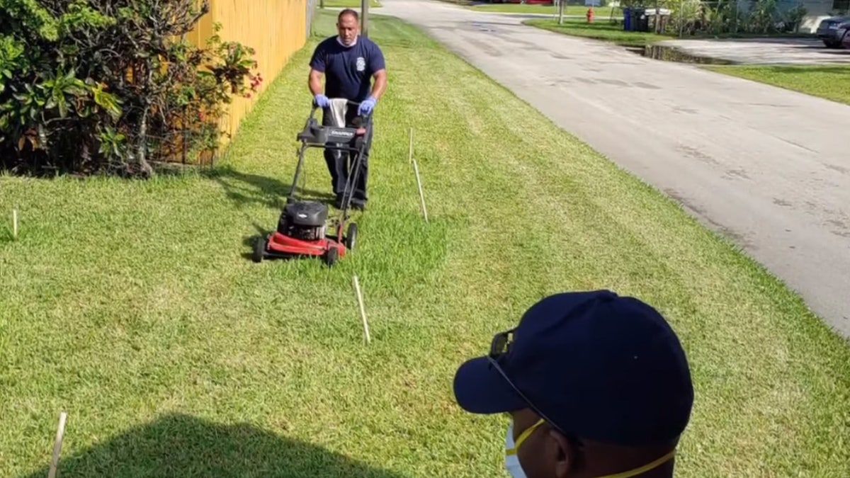 First responders from Fort Lauderdale Fire Rescue cut Prince Pinkney's grass after he was treated for heat exhaustion.