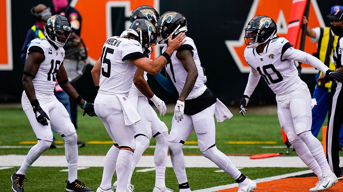 Jacksonville Jaguars wide receiver D.J. Chark (17) right celebrates a touchdown catch with quarterback Gardner Minshew (15) in the first half of an NFL football game against the Cincinnati Bengals in Cincinnati, Sunday, Oct. 4, 2020. (AP Photo/Bryan Woolston)