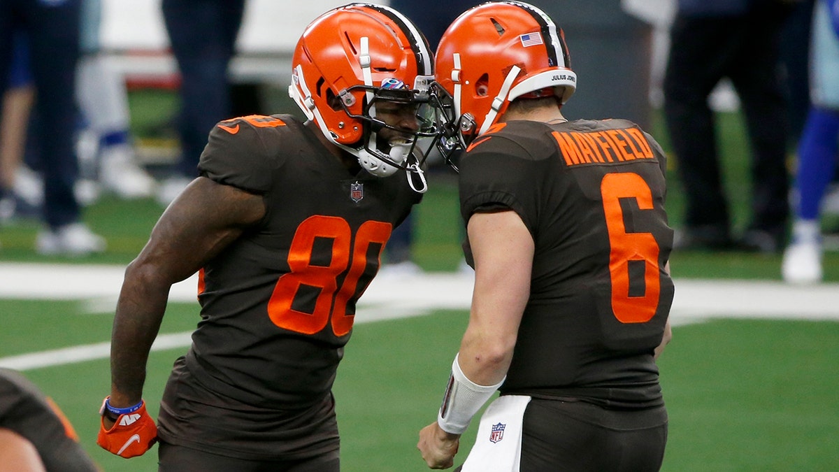 Cleveland Browns wide receiver Jarvis Landry (80) and quarterback Baker Mayfield (6) celebrate after Landry threw a touchdown pass to wide receiver Odell Beckham Jr. in the first half of an NFL football game against the Dallas Cowboys in Arlington, Texas, Sunday, Oct. 4, 2020. (AP Photo/Michael Ainsworth)