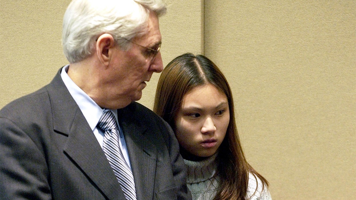 Attorney Joseph Krowski, Sr., of Brockton, Mass., has brief words with his client, Frances Choy, 17, of Brockton, Mass., during her arraignment in the Brockton District Court on two counts of murder, Friday, April 18, 2003. (AP Photo/Robert E. Klein)