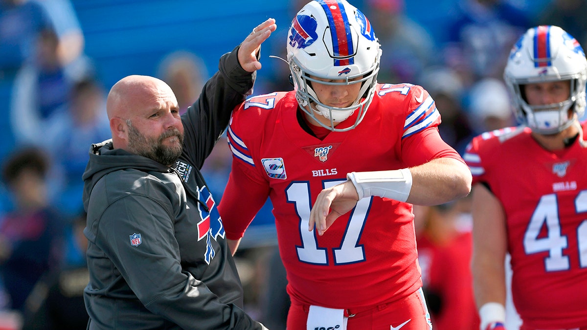 FILE - In this Oct. 20, 2019, file photo, Buffalo Bills offensive coordinator Brian Daboll, left, encourages quarterback Josh Allen as he warms up before an NFL football game Miami Dolphins, Sunday, Oct. 20, 2019, in Orchard Park, N.Y. (AP Photo/Adrian Kraus, File)