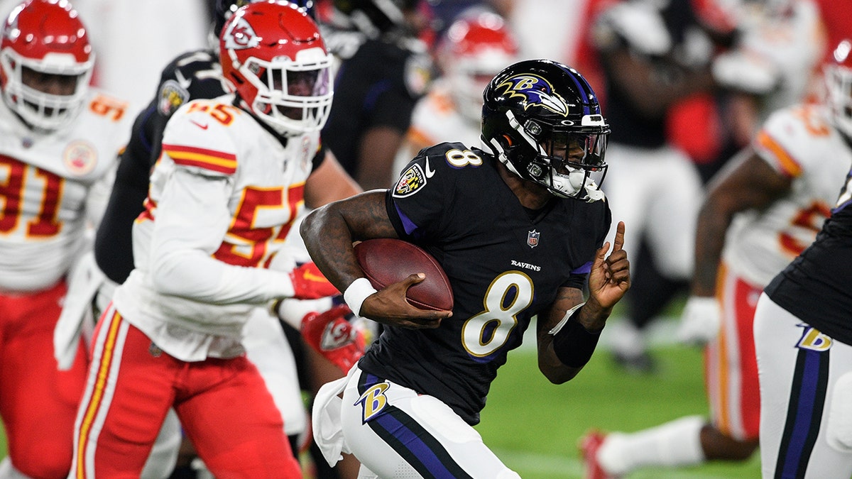 Baltimore Ravens quarterback Lamar Jackson (8) runs with the ball as he is pursued by Kansas City Chiefs defensive end Frank Clark (55) during the first half of an NFL football game Monday, Sept. 28, 2020, in Baltimore. (AP Photo/Nick Wass)