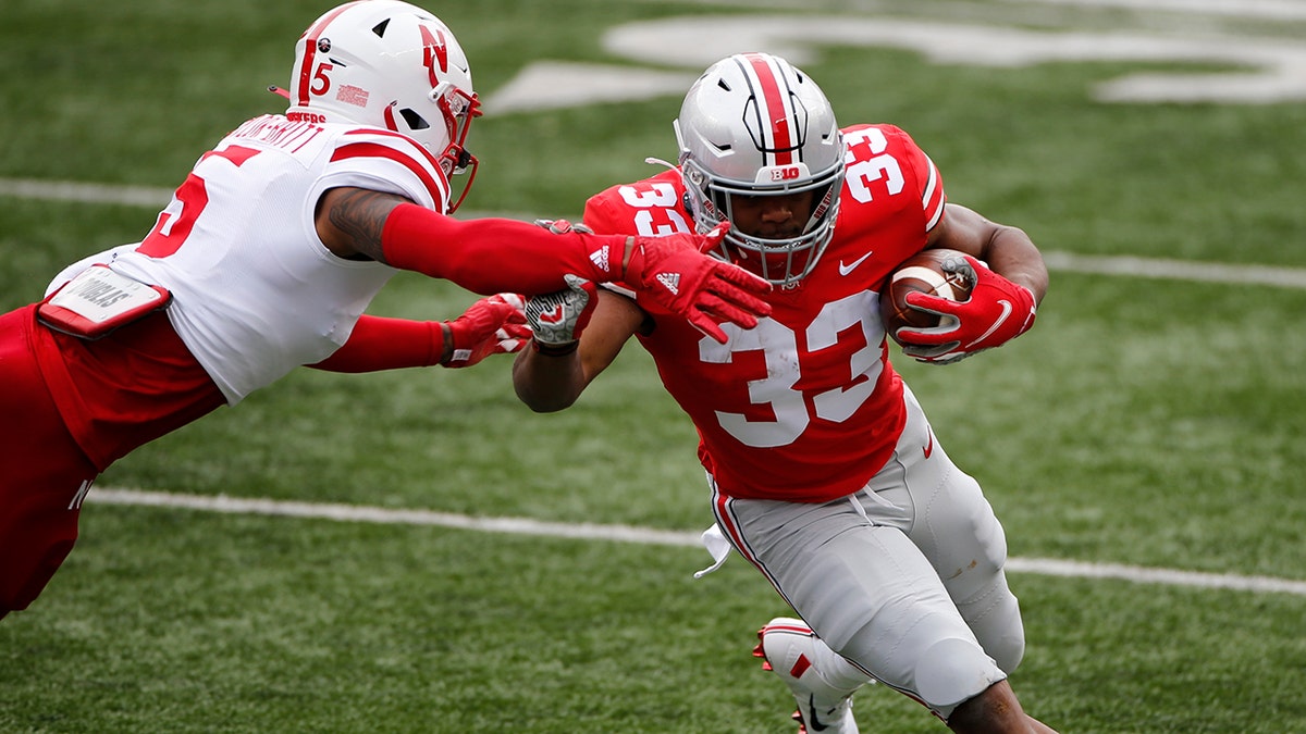 Nebraska defensive back Cam Taylor-Britt, left, forces Ohio State running back Master Teague out of bounds during the first half of an NCAA college football game Saturday, Oct. 24, 2020, in Columbus, Ohio. (AP Photo/Jay LaPrete)