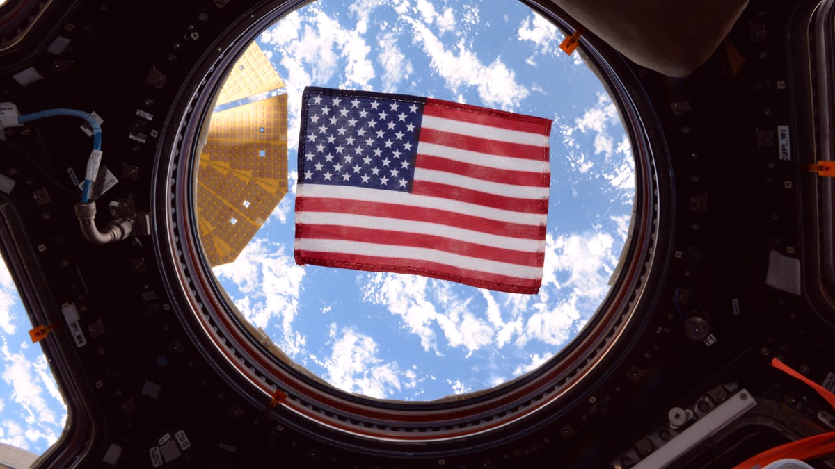 An American flag in one of the windows of the International Space Station's cupola
