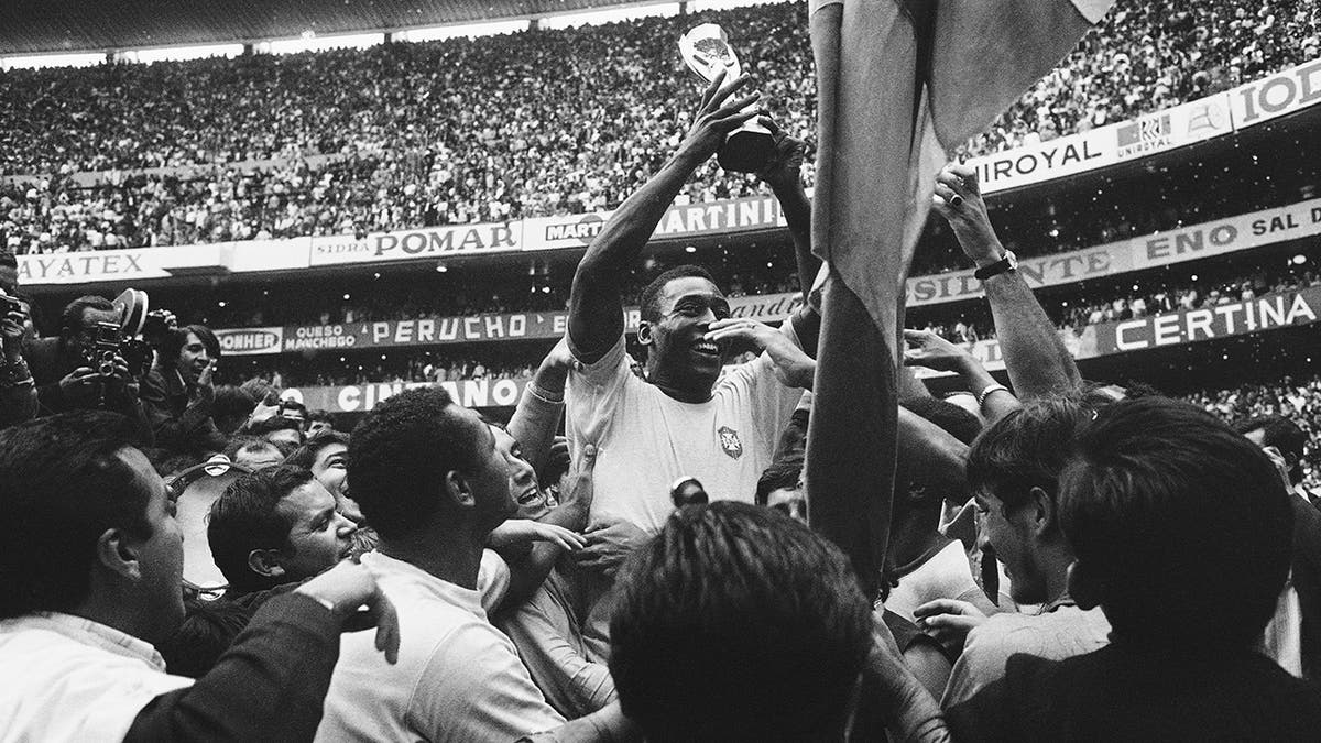 Pele holds the World Cup trophy