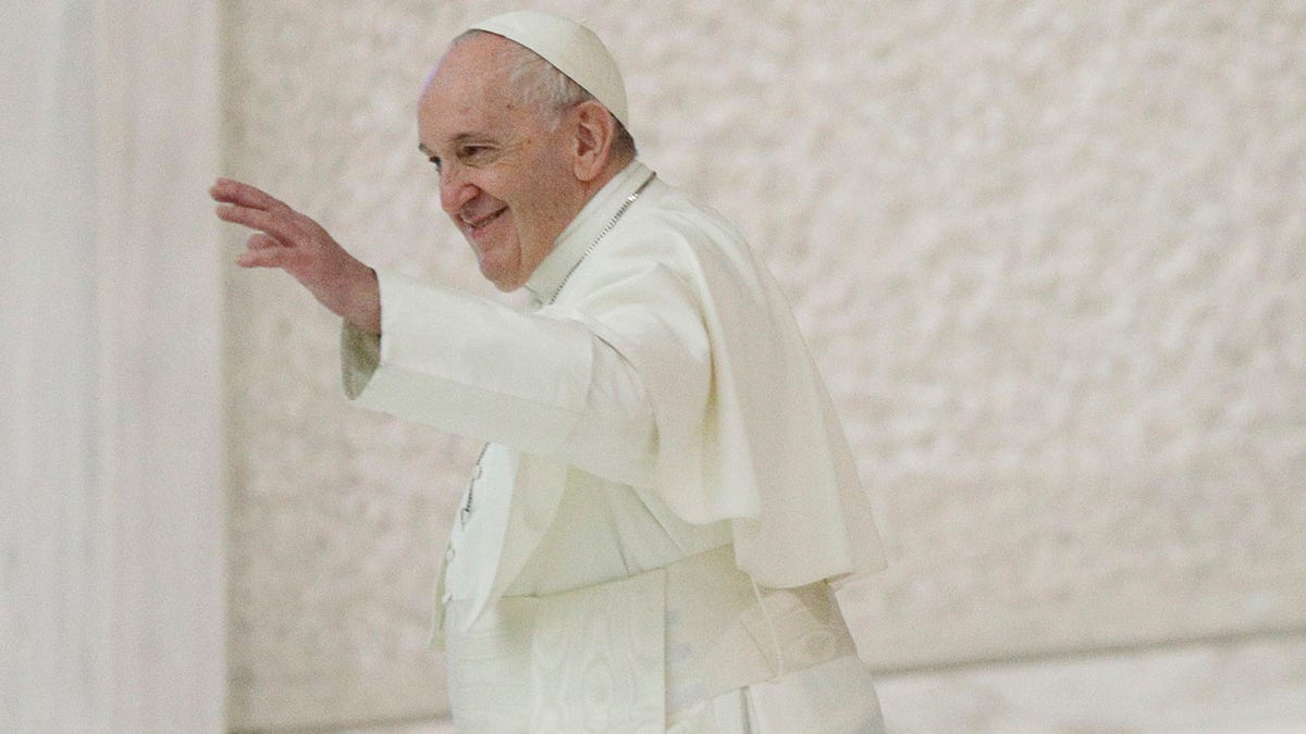 Pope Francis waves at the end of his weekly general audience in the Paul VI hall at the Vatican, Wednesday. (AP Photo/Gregorio Borgia)