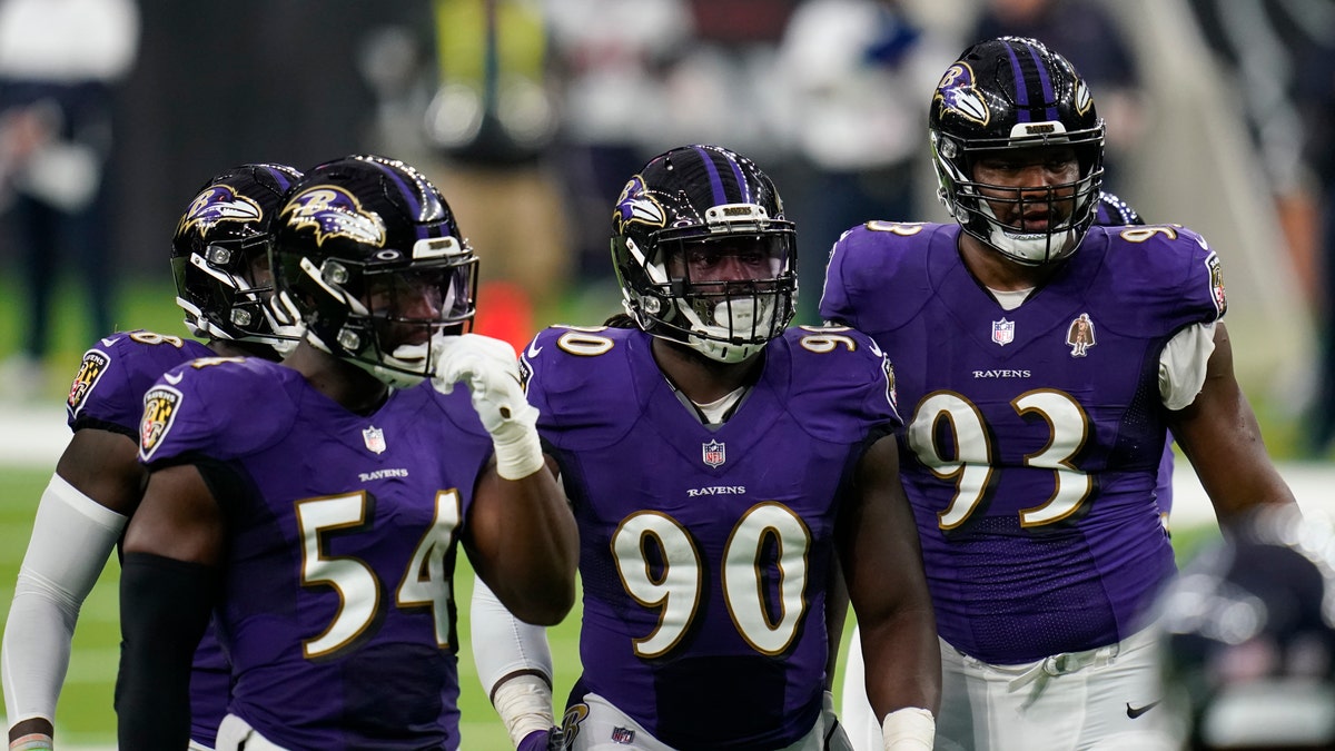 Baltimore Ravens defenders Pernell McPhee (90) Calais Campbell (93) prepare for the next play during an NFL football game against the Houston Texans, Sunday, Sept. 20, 2020, in Houston. (AP Photo/Matt Patterson)