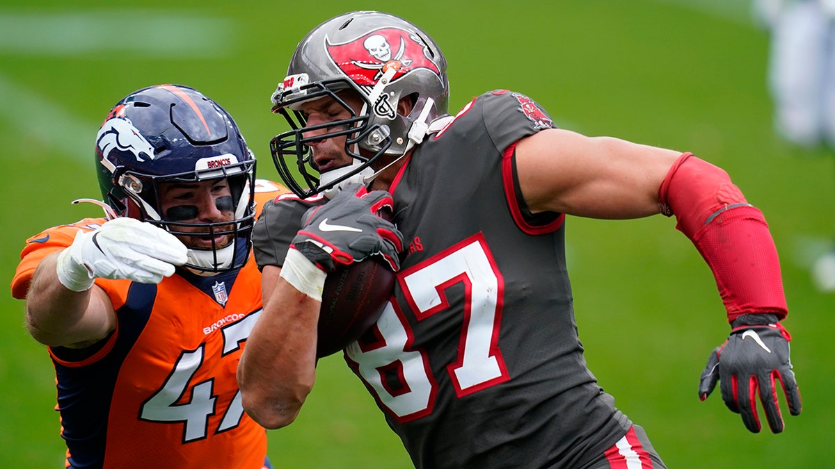 Tampa Bay Buccaneers tight end Rob Gronkowski, right, runs with the ball as Denver Broncos inside linebacker Josey Jewell defends during the first half of an NFL football game Sunday, Sept. 27, 2020, in Denver. (AP Photo/Jack Dempsey)