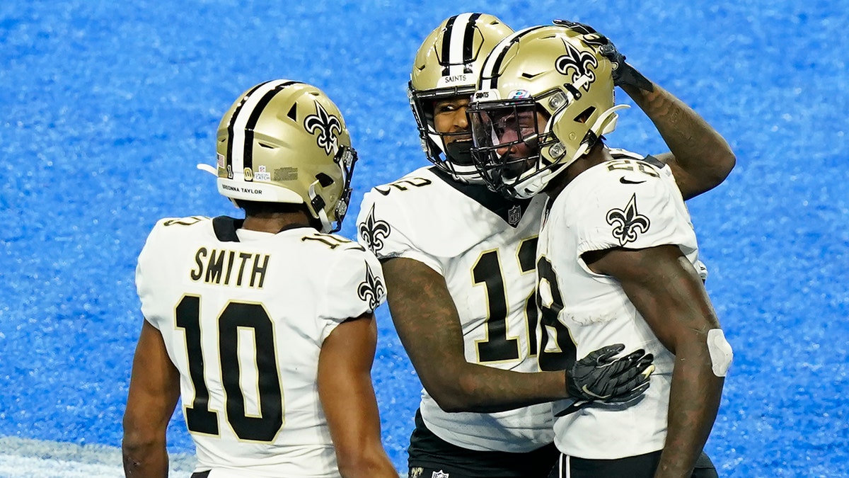 New Orleans Saints running back Latavius Murray, right, is congratulated by teammates wide receivers Marquez Callaway (12) and Tre'Quan Smith (10) after scoring on a 6-yard run during the second half of an NFL football game against the Detroit Lions, Sunday, Oct. 4, 2020, in Detroit. (AP Photo/Carlos Osorio)