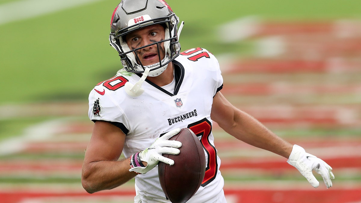 Tampa Bay Buccaneers wide receiver Scott Miller (10) scores on a 19-yard touchdown pass from quarterback Tom Brady during the second half of an NFL football game against the Los Angeles Chargers, Sunday, Oct. 4, 2020, in Tampa, Fla. (AP Photo/Mark LoMoglio)