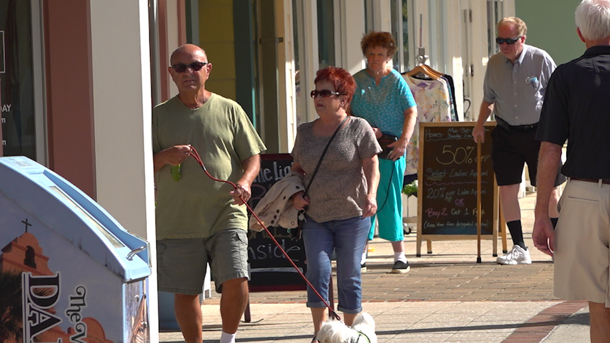 Residents of The Villages retirement community walking around the Lake Sumter Landing area. Senior citizens make up over 20% of Florida's population according to 2019 Census estimates (Robert Sherman, Fox News).