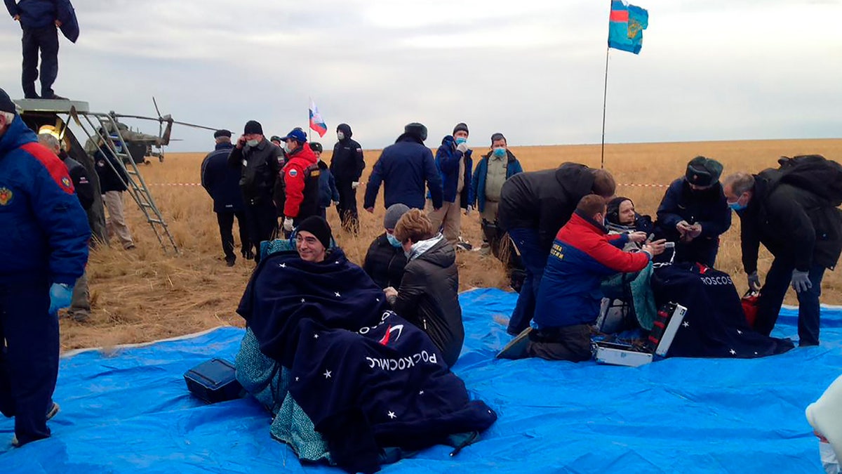 In this photo released by Roscosmos Space Agency, Roscosmos' cosmonauts Anatoly Ivanishin, left, and Ivan Vagner sit in fchairs shortly after the landing near town of Dzhezkazgan, Kazakhstan, Thursday, Oct. 22, 2020.